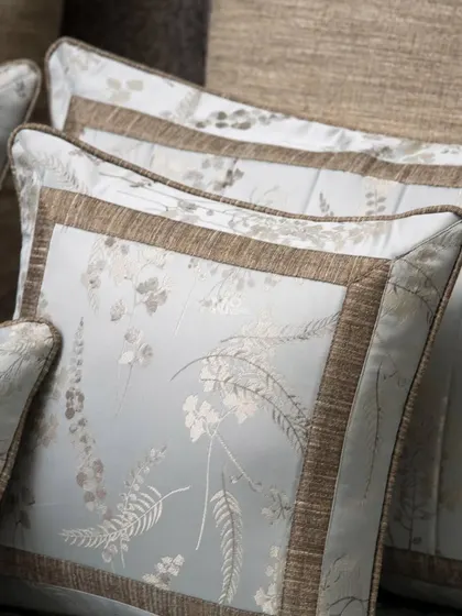 The pillows from our Essential Grey Jacquard set, showcasing the elegant botanical pattern and contrasting textured border, crafted for modern living.