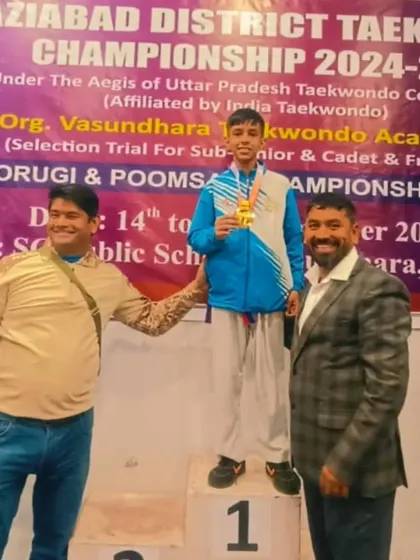 This champion stands proudly on the podium after winning his gold medal at the district championship.