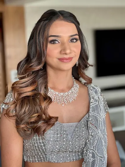 A bright and happy shot of this shimmering look. The makeup is designed to enhance her features and make her sparkle all night long.