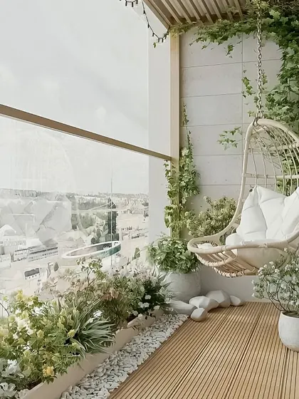 A bright and airy balcony with a comfortable hanging swing chair. The design uses light colors, planters with white flowers, and a wooden deck to create a peaceful and chic retreat.