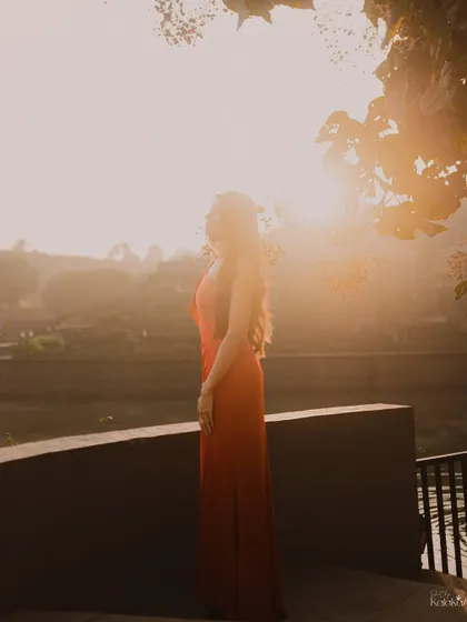 A beautiful silhouette of the bride against the golden morning sun, creating a serene and hopeful portrait.