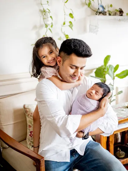 A proud dad with his two little ones. I make sure to get photos of every combination, including special moments with just dad or mom.