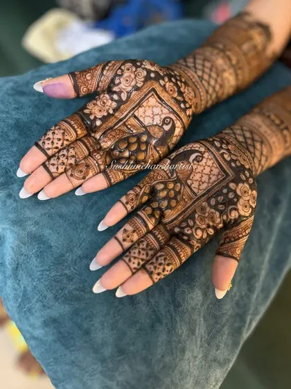 Another angle of this beautiful peacock-themed bridal design, showing the fine details and the rich color of the henna.