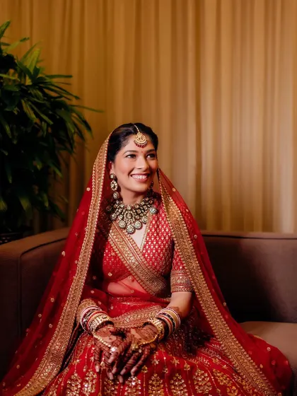 Sonali was a picture of regal grace for her wedding ceremony. I created a classic bridal look with defined eyes and a warm glow that perfectly complemented her traditional red Sabyasachi lehenga.