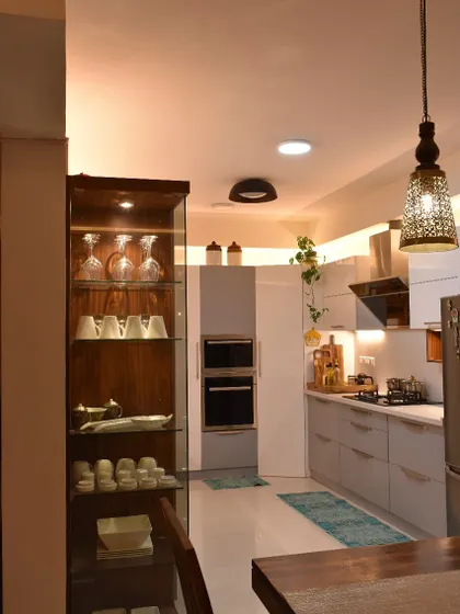 Another shot of the kitchen, highlighting the beautiful contrast between the dark wood of the crockery unit and the light grey cabinets.
