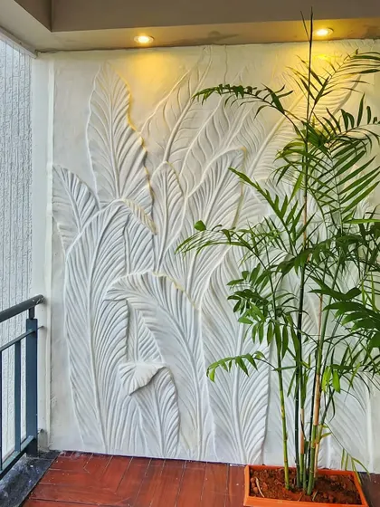 A different angle of the plaster-molded leaf sculpture. The three-dimensional texture interacts with natural and artificial light, creating depth and changing shadows throughout the day.