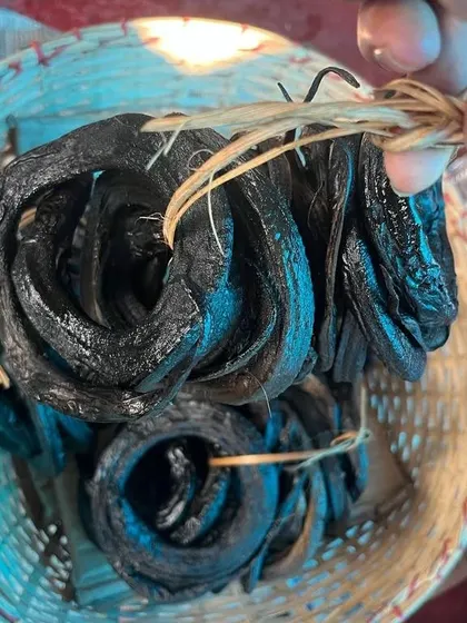 This is smoked eel, a delicacy in Nagaland. It is carefully dried and smoked, then coiled and tied for sale at the market, ready to be used in rich, flavorful curries.