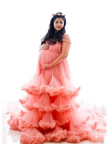 A high-key portrait in a peach-colored ruffled gown. The bright background gives the image a light and airy feel.