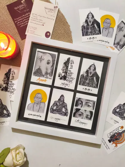 Another view of the framed postcard art, set against a warm, inviting background with a candle and a white rose.