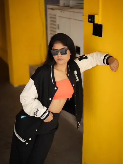 A duplicate of image 490, this portrait of a model in a varsity jacket, looking over her shoulder, is stylish and confident.
