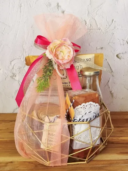 This geometric golden basket holds a mix of our sweet and savory treats, beautifully wrapped to create a lasting impression. We can customize the contents for any event.