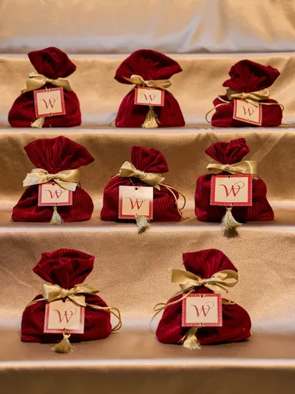 A lineup of the velvet Festive Bundles. These potlis, tied with a golden ribbon and a custom tag, were a bestseller for Diwali, perfect for bulk orders.