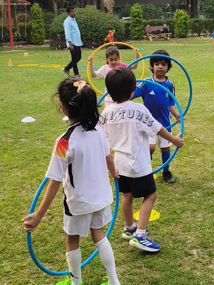 Teamwork makes the dream work, even at this age. Children in our First Kicks program learn to cooperate and move together through fun hula hoop exercises.