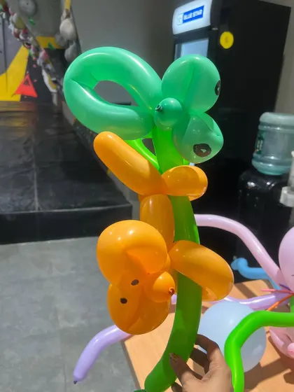 Balloon twisting is a fun art form. Our artists can create all sorts of amazing things, like this monkey climbing a tree.