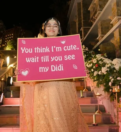 "You think I'm cute, wait till you see my Didi." A sweet and funny sign held by the bride's sister, making the entry even more special.