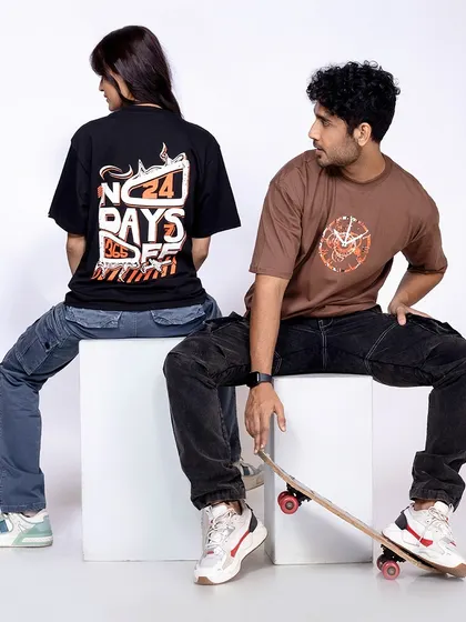 Two models, male and female, in oversized t-shirts and cargo pants, showcasing a trendy, urban streetwear look.