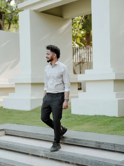 A casual men's lifestyle portrait in a modern outdoor setting. This type of shot is perfect for personal branding or social media profiles.
