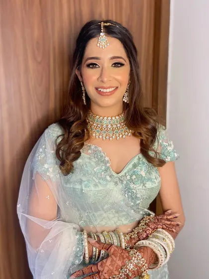Aashna's happiness shines through. Her dewy skin finish and bright smile are the perfect accessories to her stunning bridal ensemble.