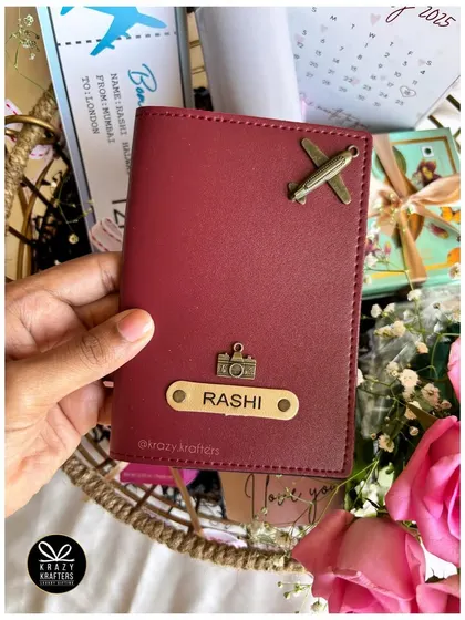 A personalized passport cover with custom charms, a perfect addition to a travel-themed or countdown hamper.