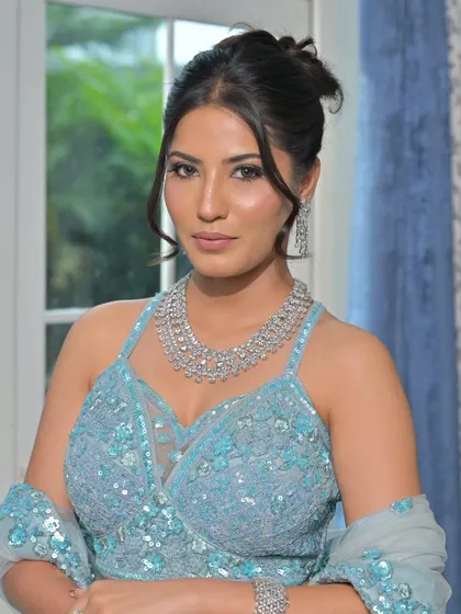 A modern, fashion-forward look featuring a pearl-encrusted gown. The simple diamond drop earrings are the perfect accessory for this statement outfit.