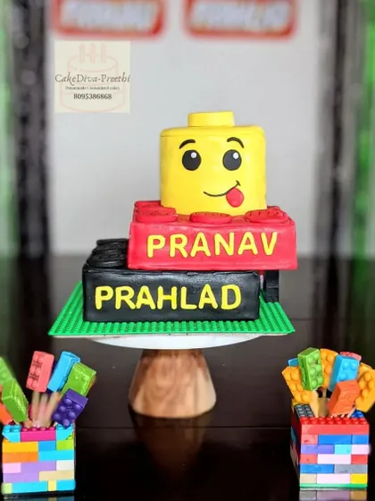 Le-go of your worries and have some cake! This Lego-themed cake features a Lego head and blocks, all carved from cake. The edible Lego bricks in the front are made from chocolate.
