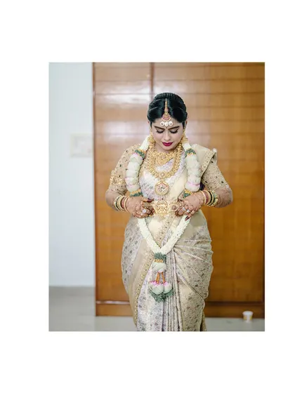 A full-length view of the bride Diana, showcasing her entire wedding look, from the custom blouse to the elegant saree drape.