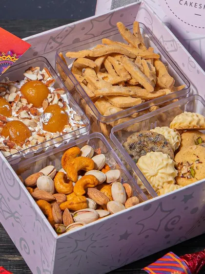 Our Diwali Wholesome Hamper features a delicious Gulab Jamun cake tub. It's a modern take on a classic dessert, with soft cake and chunks of gulab jamun in a creamy base.
