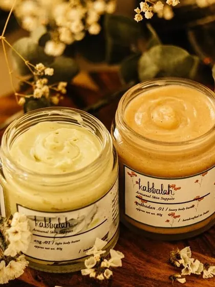 Here are two of my favorite body butters, the light 'Ang' and the heavy 'Gulbadan'. Each is whipped to a perfect consistency to deeply nourish your skin, showing the variety of textures I create for different skin needs.