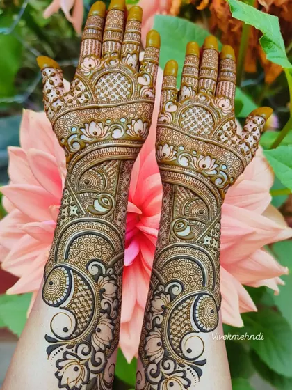 A gorgeous full-hand design with swirling peacock and floral patterns. The shading and fine lines create a beautiful 3D effect.