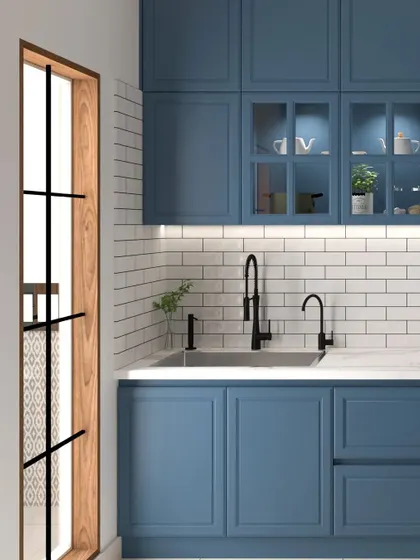 This angle shows the matte black faucet and sink, which provide a modern contrast to the classic blue cabinets and white countertop in this shaker-style kitchen.