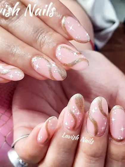A whimsical design with a pink base, gold swirls, and tiny white starbursts, creating a magical, celestial look.