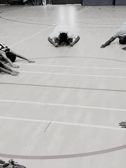 A cool-down session is just as important as the main workout. Here, our players are performing deep stretches in a circle, helping with muscle recovery and promoting mindfulness after an intense training session.