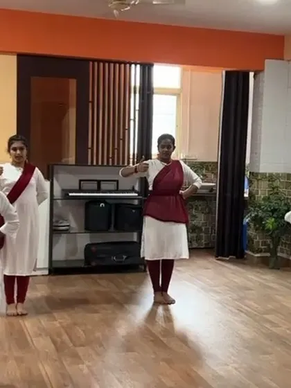 Students practicing their Bharatanatyam movements in our mirrored studio, which allows them to self-correct and perfect their form.