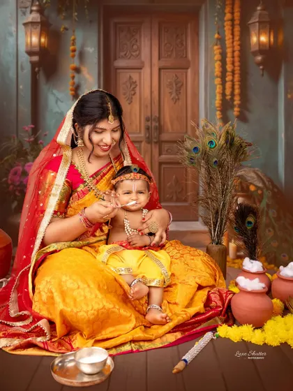 A candid moment where "Yashoda" is feeding her little "Krishna," capturing a sweet and nurturing interaction.