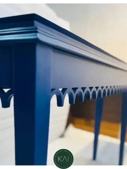 A detail shot of the blue console table, focusing on the crisp lines of the tabletop and the delicate cut-out pattern.