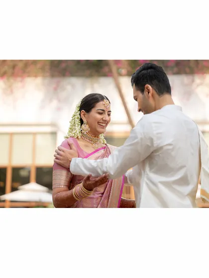 This candid photo captures a sweet moment between the bride and groom. The pastel Kanjivaram saree, draped by me, looks elegant and allows the bride to move with ease and grace.