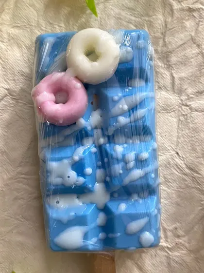 A bright blue popsicle soap, also topped with mini donut soaps. It's a playful design that makes washing hands feel like a treat.