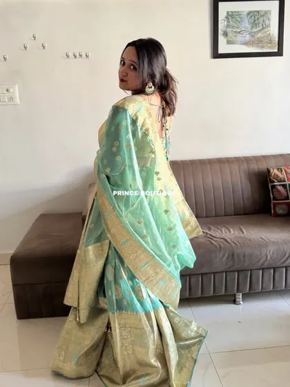 The back view of the Banarasi lehenga, showing the elegant drape of the dupatta and the stylish back of the blouse.