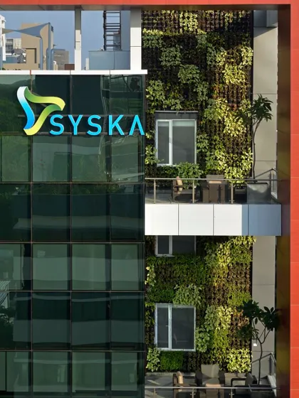 A close-up of the green wall on the Syska building, showing the density and texture of the vertical garden.