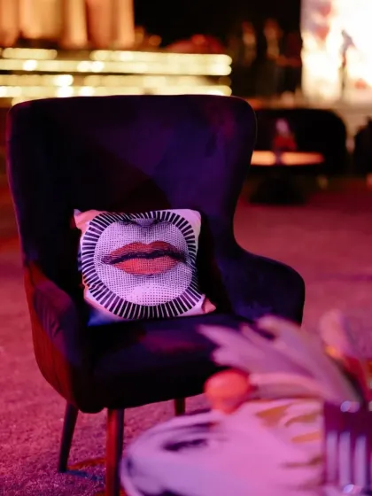 A plush armchair with a pop-art cushion. We carry the theme through to the smallest details, including the soft furnishings, to ensure a cohesive design.