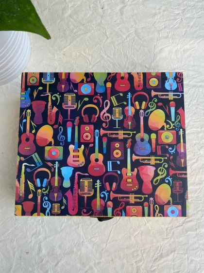 A top-down view of the music-themed box, showing the detailed and lively decoupage paper I used for the lid.