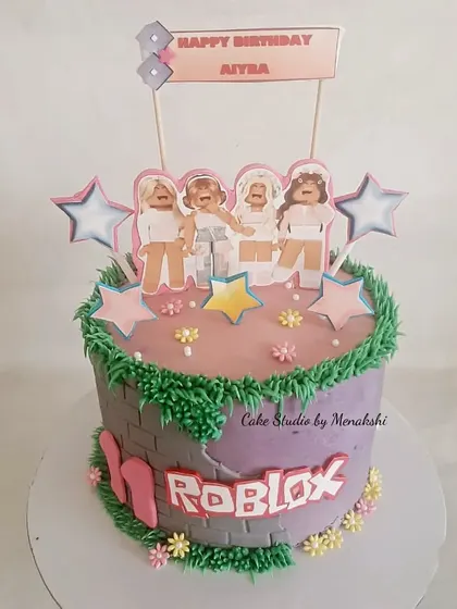 A Roblox themed cake for Aiyra. This design has a girly touch with pink and purple colors, flowers, and a group of girl characters from the game.