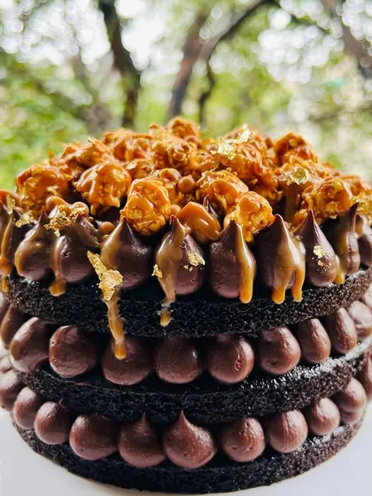 The perfect treat for a rainy day. This is my naked chocolate cake with salted caramel, chocolate ganache dollops, and a topping of crunchy caramel popcorn.