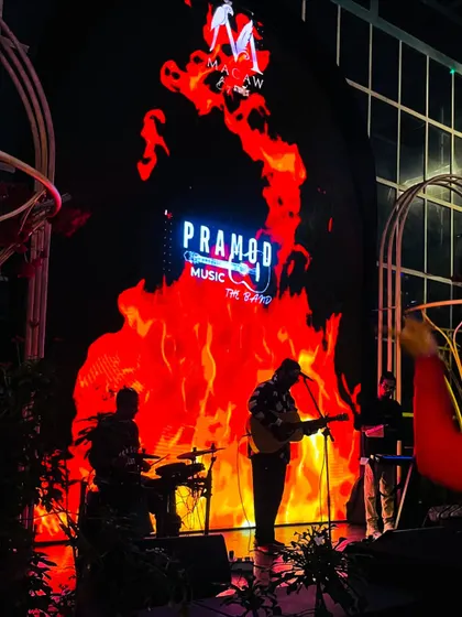 Here is my full band on stage, silhouetted against a dynamic LED backdrop. We use professional lighting and visuals to create a powerful stage presence that elevates the atmosphere of any large pub or event space.