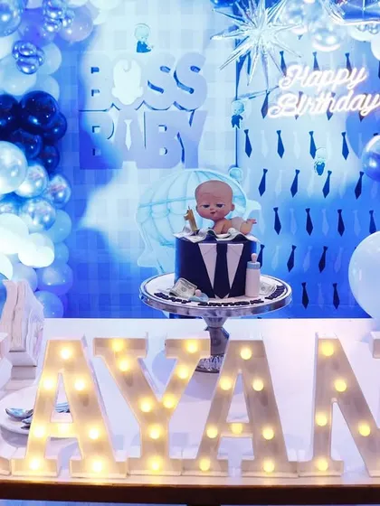 A full view of our Boss Baby birthday setup. This shows the main cake table with light-up marquee letters, a themed backdrop, and coordinated balloon columns, creating a cohesive and impressive look.