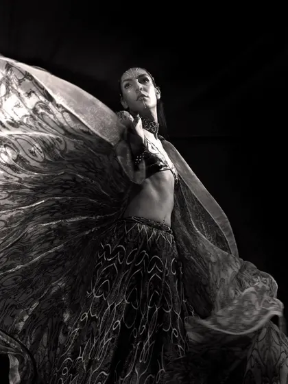 Black and white photography allows me to focus on form, emotion, and movement. This image captures a dancer mid-motion, the swirling fabric creating an abstract, wing-like shape that conveys a sense of freedom and artistic expression, ideal for a powerful editorial story.