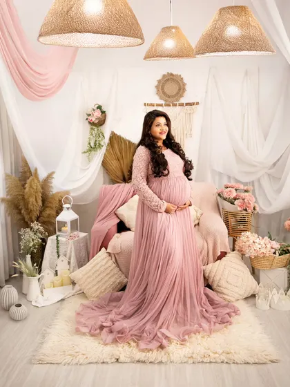 A vision in dusty pink. This full-length portrait showcases our romantic, pink-themed boho setup, complete with pampas grass, candles, and soft fabrics.