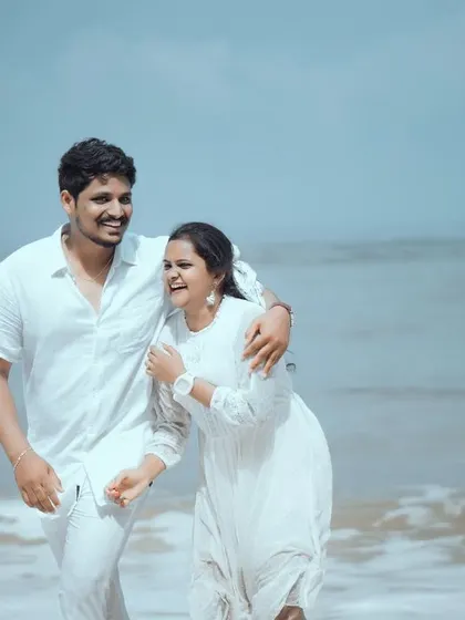 The pure, unscripted joy of a couple's walk on the beach. My goal is to capture these natural, candid moments of laughter that truly reflect your relationship.