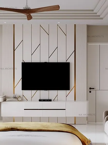 This view shows the TV and study area in the grey and gold bedroom. The wall paneling with golden inlays continues here, creating a cohesive design that is both beautiful and functional.