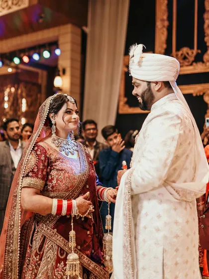 A candid moment during the wedding ceremony, capturing the genuine smiles and interaction between the bride and groom.